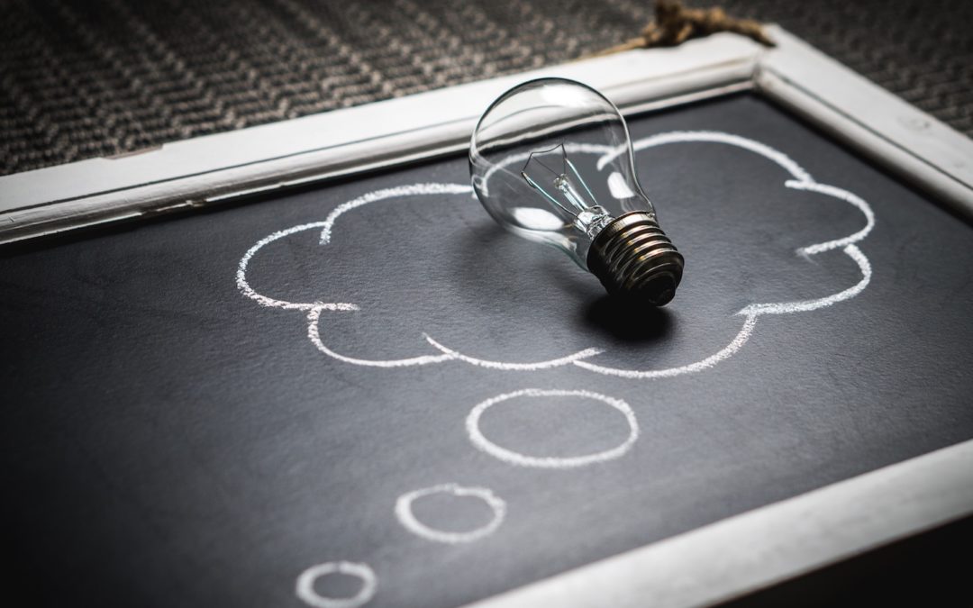 lightbulb on a chalkboard surrounded by thought cloud
