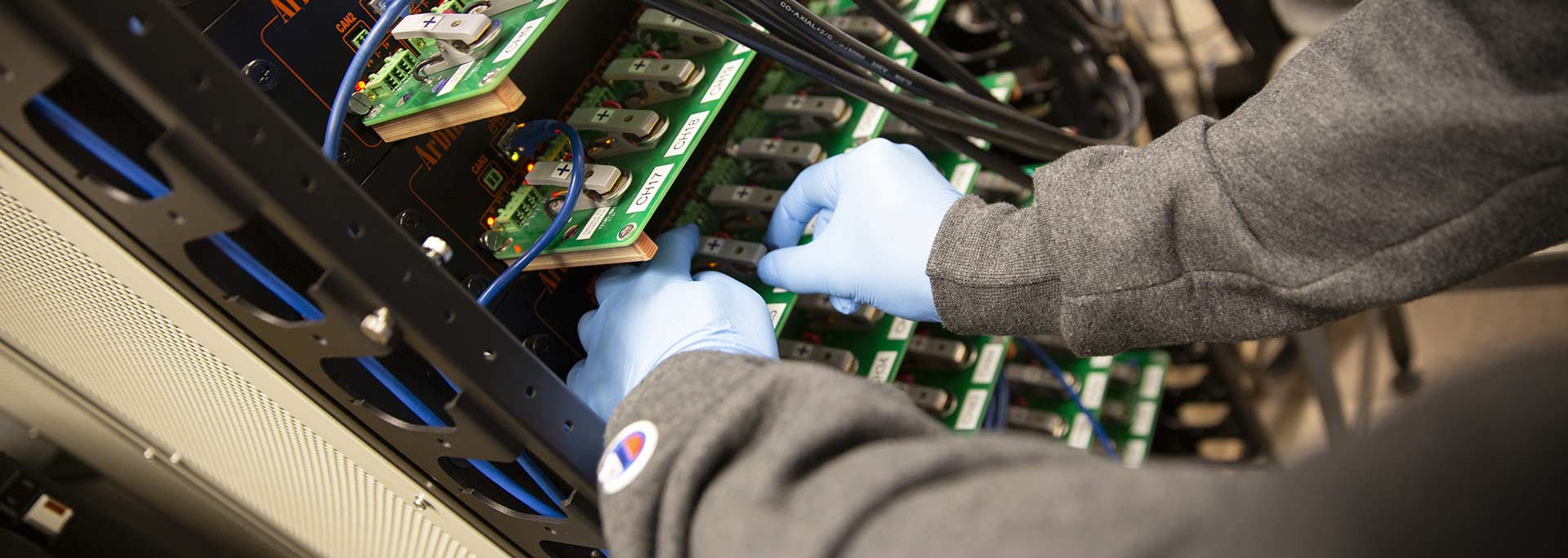 Close up of hands working with wires.