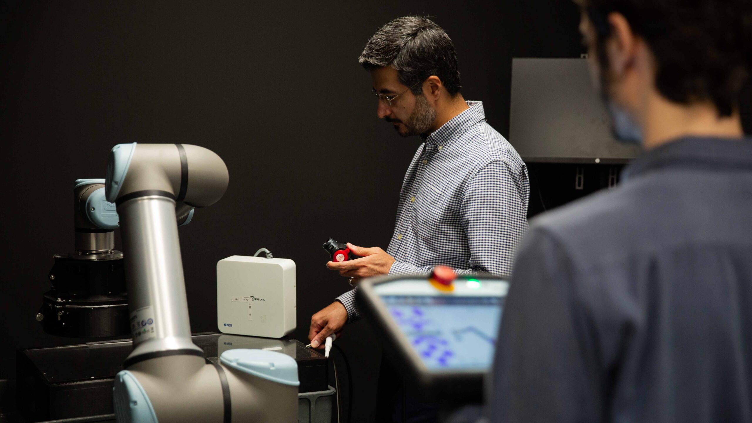 Man working with robot.