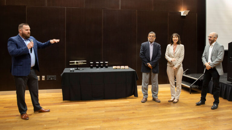 Michael Bessolo (left) presents mementos from the “More Electric, More Efficient” Aircraft Industry Day event to (from center left to right) Anthony Waas, Amy Jankovsky and Todd Giles. Photographer: Erika Gronek/ASU