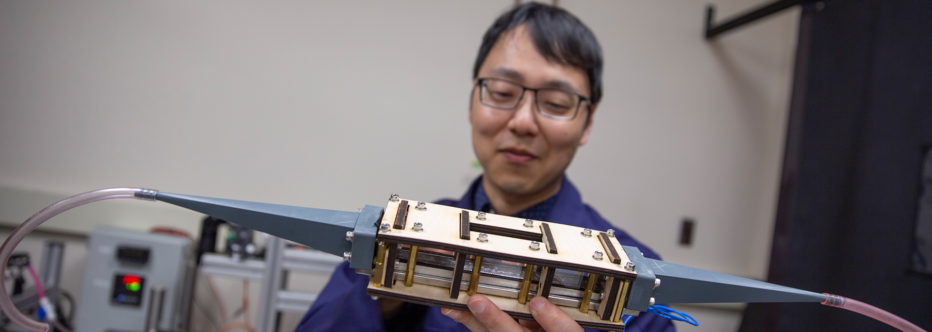 Assistant Professor Beomjin Kwon holding equipment in his lab at ASU