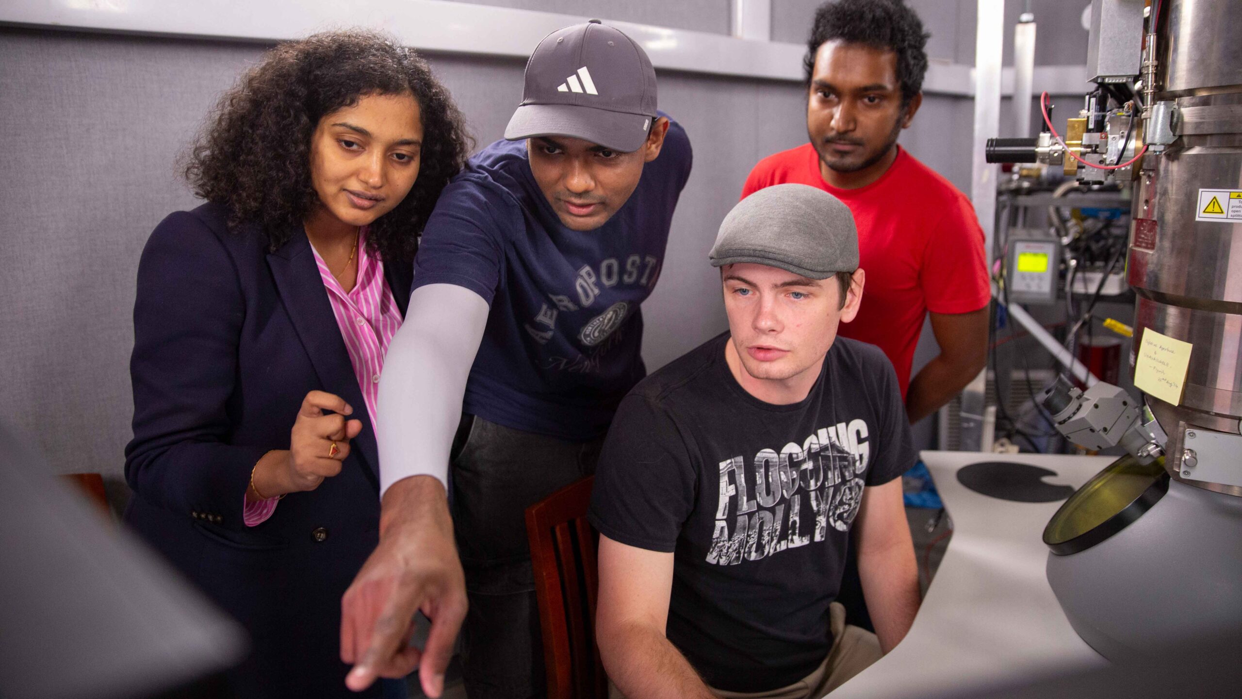 Pictured left to right: Sandhya Susarla, assistant professor in the School for Engineering of Matter, Transport and Energy, part of the Ira A. Fulton Schools of Engineering at Arizona State University, is shown with her students, Sriram Sankar, Patrick Hays and Mahir Manna, in a microscopy lab at ASU. She recently received the 2025 Society Awards from the Microscopy Society of America, the highest early career honor in the field of microscopy. Photographer: Erika Gronek/ASU