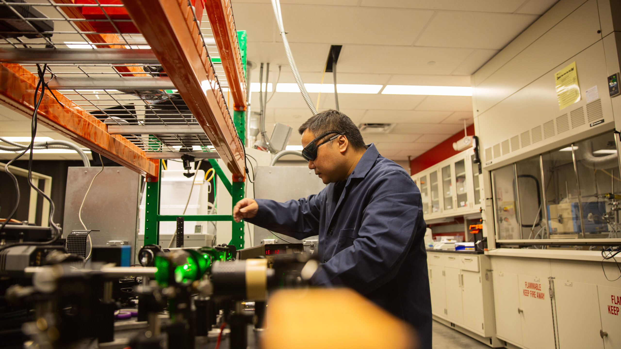 Sui Yang, an assistant professor of materials science and engineering in the School for Engineering of Matter, Transport and Energy, part of the Ira A. Fulton Schools of Engineering at Arizona State University, operates equipment in his lab. He recently published a paper in Nano Letters about a novel way to manipulate light at the nanoscale using 3D printing, a capability that was previously out of reach. Photographer: Roger Ndayisaba/ASU